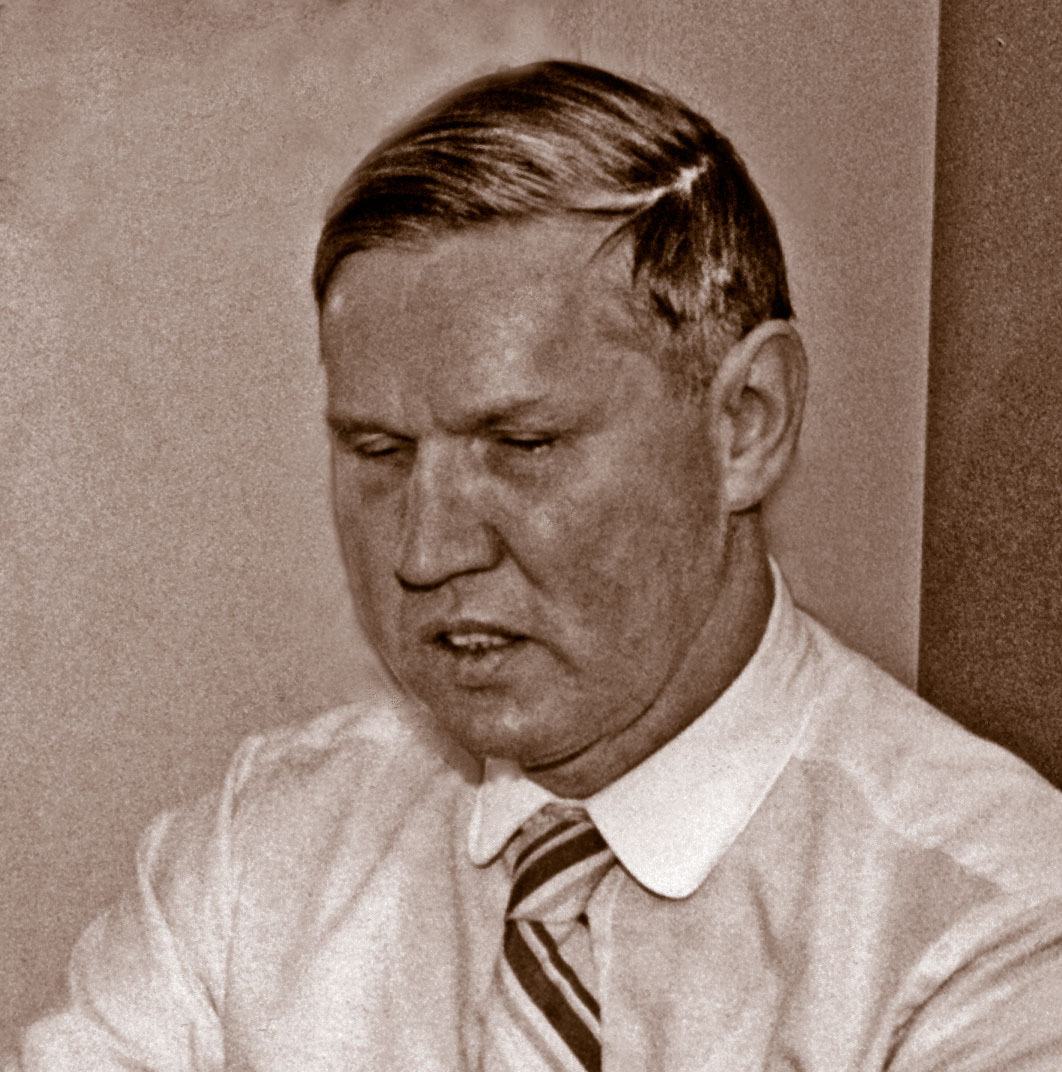 Head-shot portrait of Richard Evansen in a white shirt with a striped tie